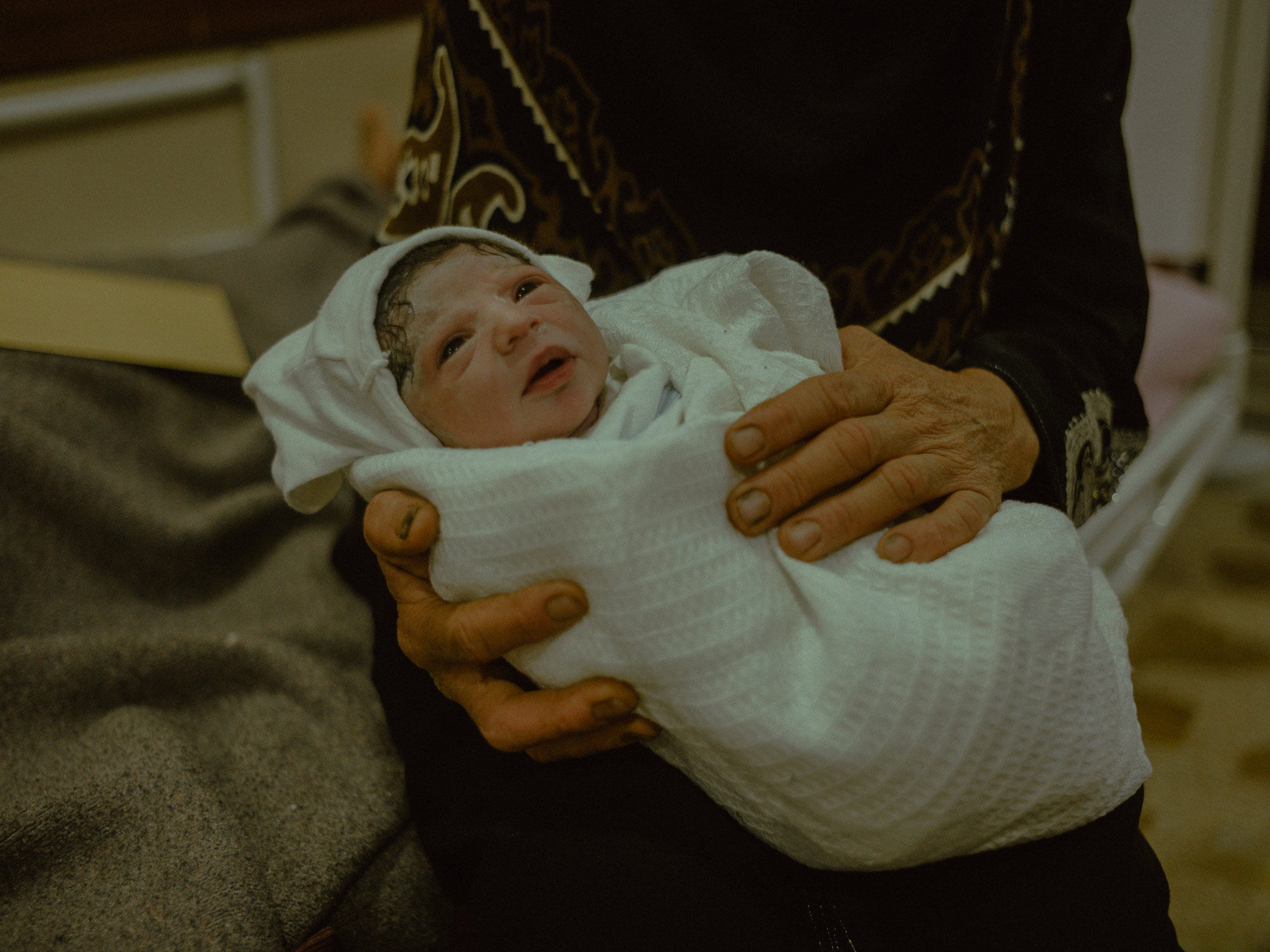 Irak. Mossoul. 17 septembre 2021. Noor Ibrahim, un nouveau-né, dans les bras de sa grand-mère Shaima à l'hôpital MSF de Nablus. Ils viennent de Rabia, une ville à la frontière avec la Syrie, à 120 kilo mètres de Mossoul. 